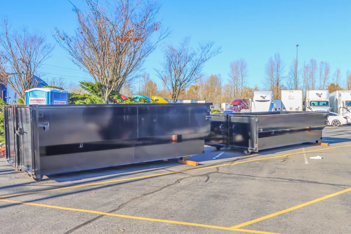 Professional dumpster rental service with roll-off container on residential driveway in Binghamton